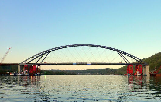 Wellsburg bridge span partly lowered onto piers