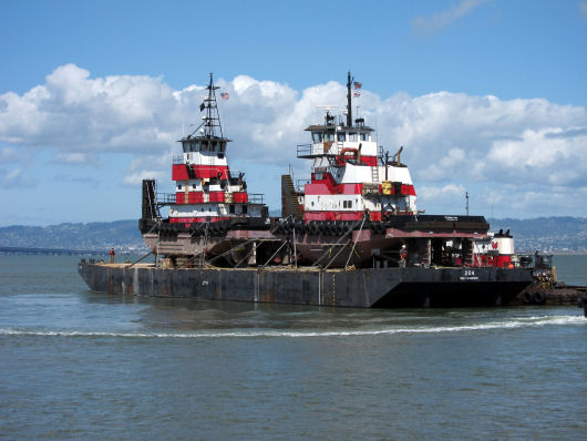 Barge 204 loaded with tugs departs San Francisco 